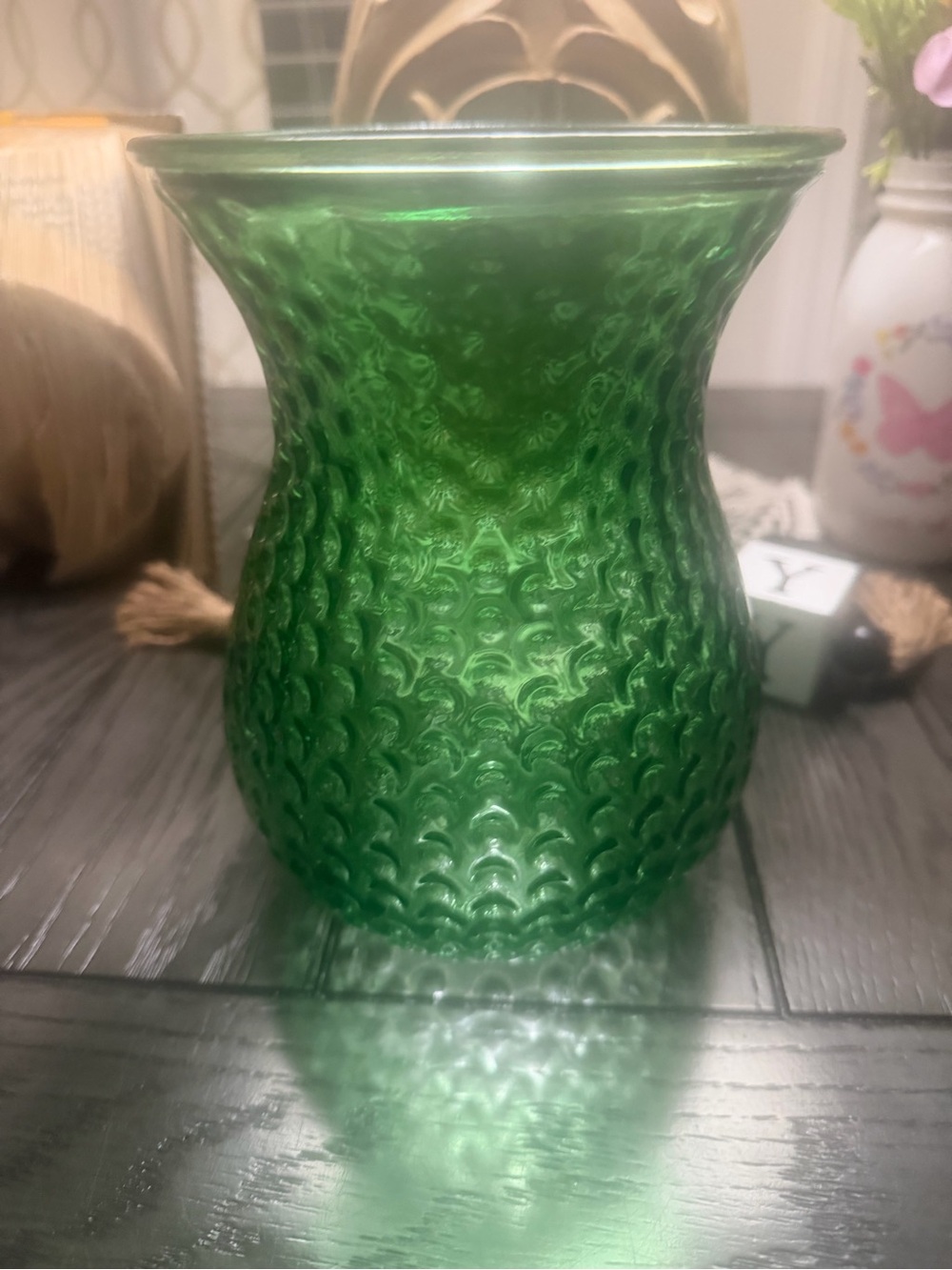 This is a vintage green glass Hoosier vase featuring a textured raised bubble.